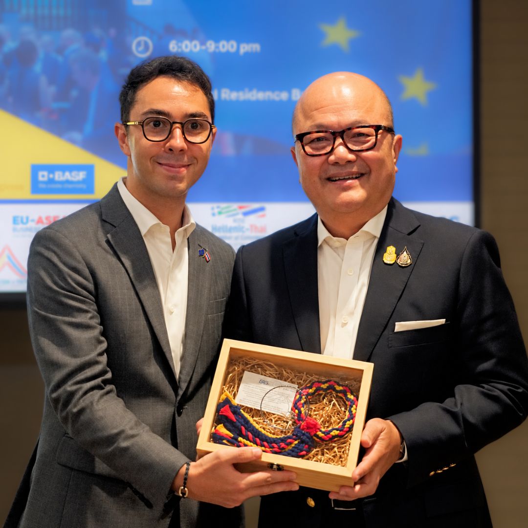 Two people presenting a customized Malai corporate gift in a wooden box